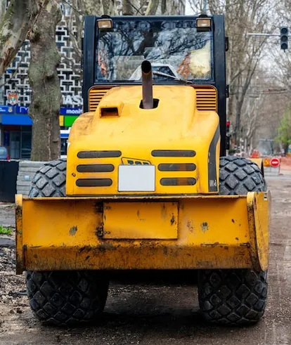 Yellow road roller on a Chișinău street dug back to its base